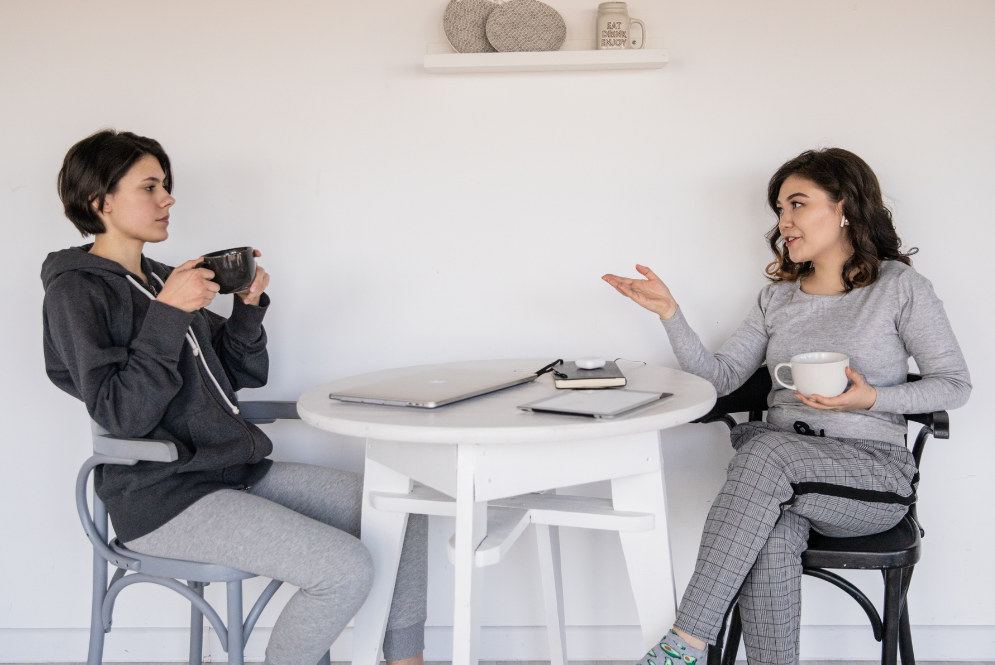 Two woman talking over a cup of coffee - The Private Practice Pro