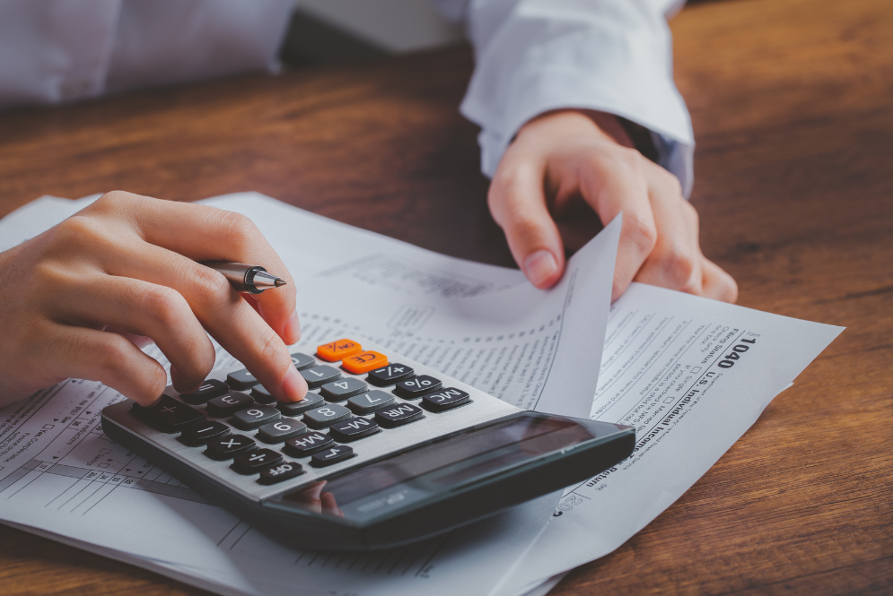 A woman computing using a calculator - The Private Practice Pro 