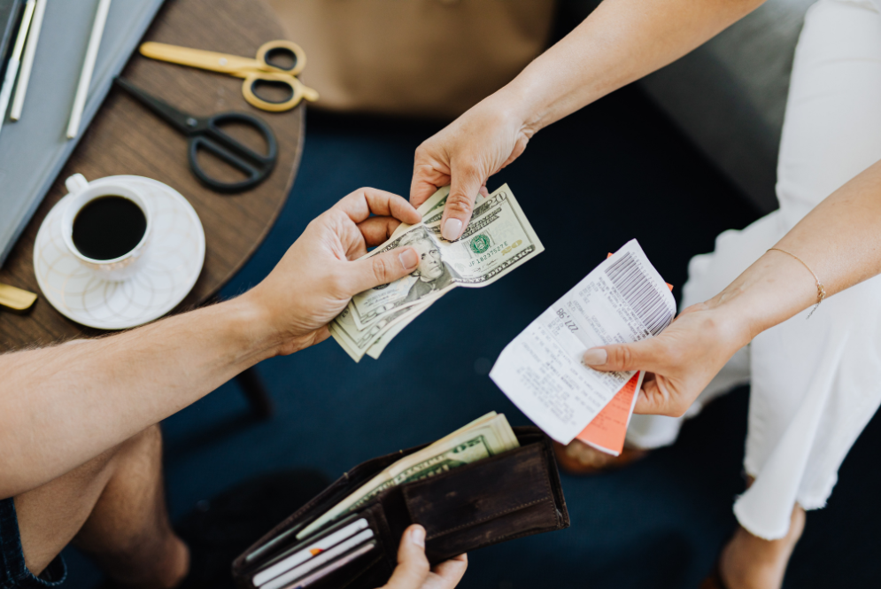 Two people—one paying, the other handing over receipts - Insurance queries therapy
