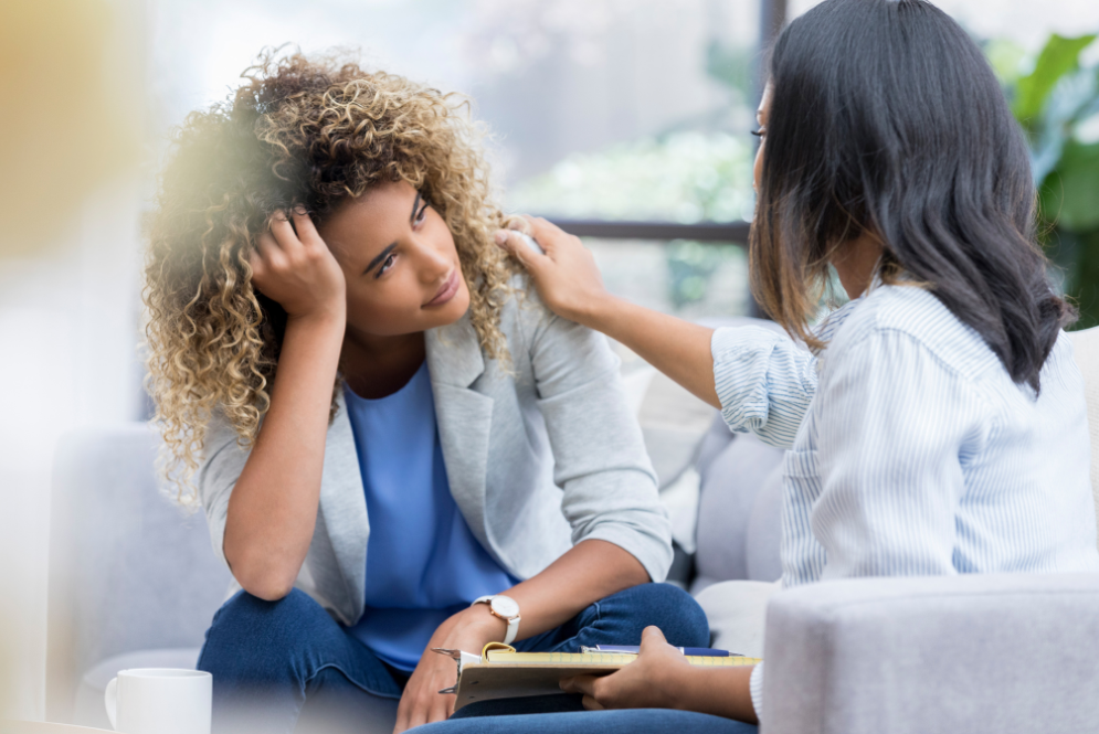 Two women sitting, one comforting the other – The Private Practice Pro